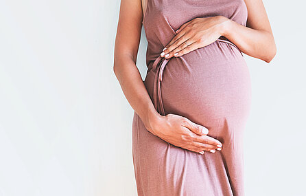 A pregnant woman holds her belly