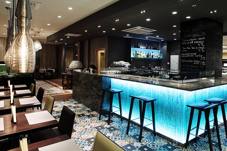Blue-lit hotel bar at Gastronome Riga Restaurant