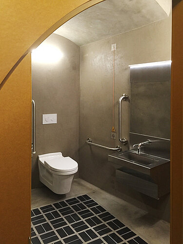 Public bathroom with rimless toilet at Building Centre London