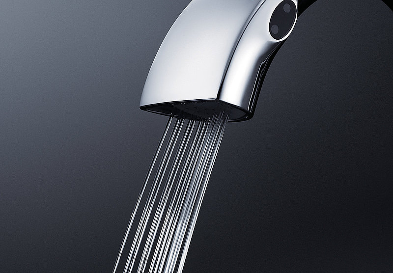 This picture shows the spout of a faucet. Thin jets of water run out of the spout.