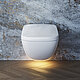 The picture shows a modern, wall-hung toilet in front of a wall with a striking marble look and a warm glow of light on the floor, giving the room a stylish and elegant atmosphere.