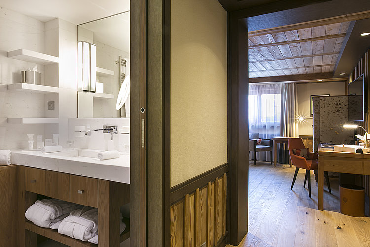 Suite with bathing and living areas at  Hotel Les Neiges in Courchevel